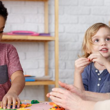 Preschool kids on kindergarten activities with their teacher