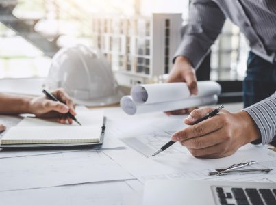 Construction and structure concept of Engineer or architect meeting for project working with partner and engineering tools on model building and blueprint in working site.